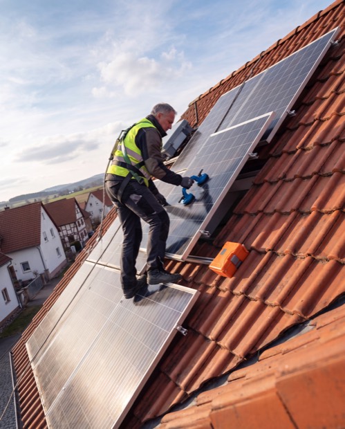 Roofer installing a solar system