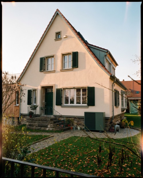 Heat pump in the front yard of a single-family home